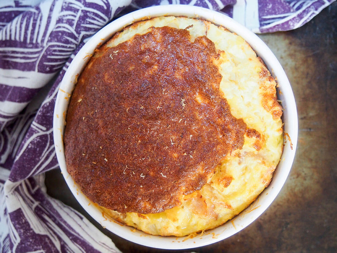 speck potato and cheese souffle in souffle dish from overhead