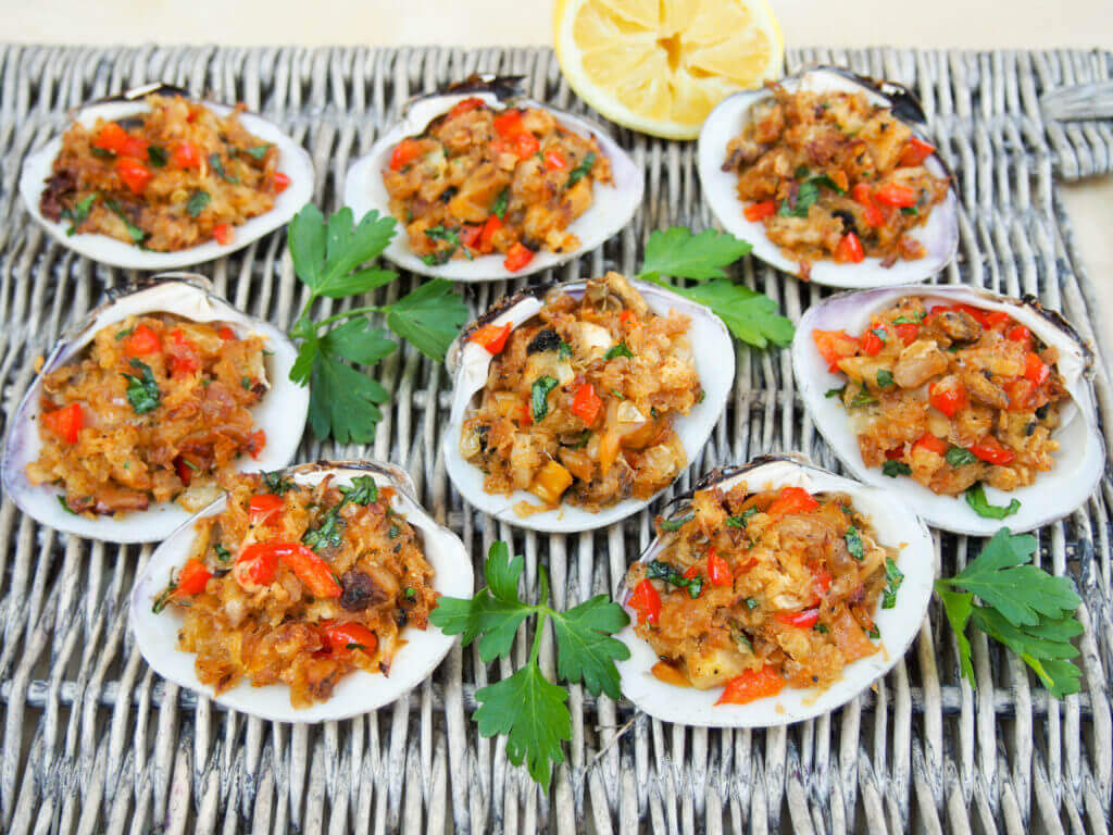 New England style stuffed clams are a delicious appetizer made with steamed clams & seasoned buttered breadcrumbs, baked until crisp on top but moist within