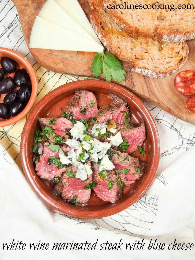 Dish of white wine marinated stead with blue cheese