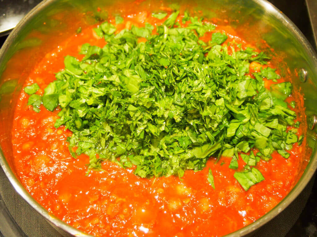 making chickpea, lentil and spinach curry