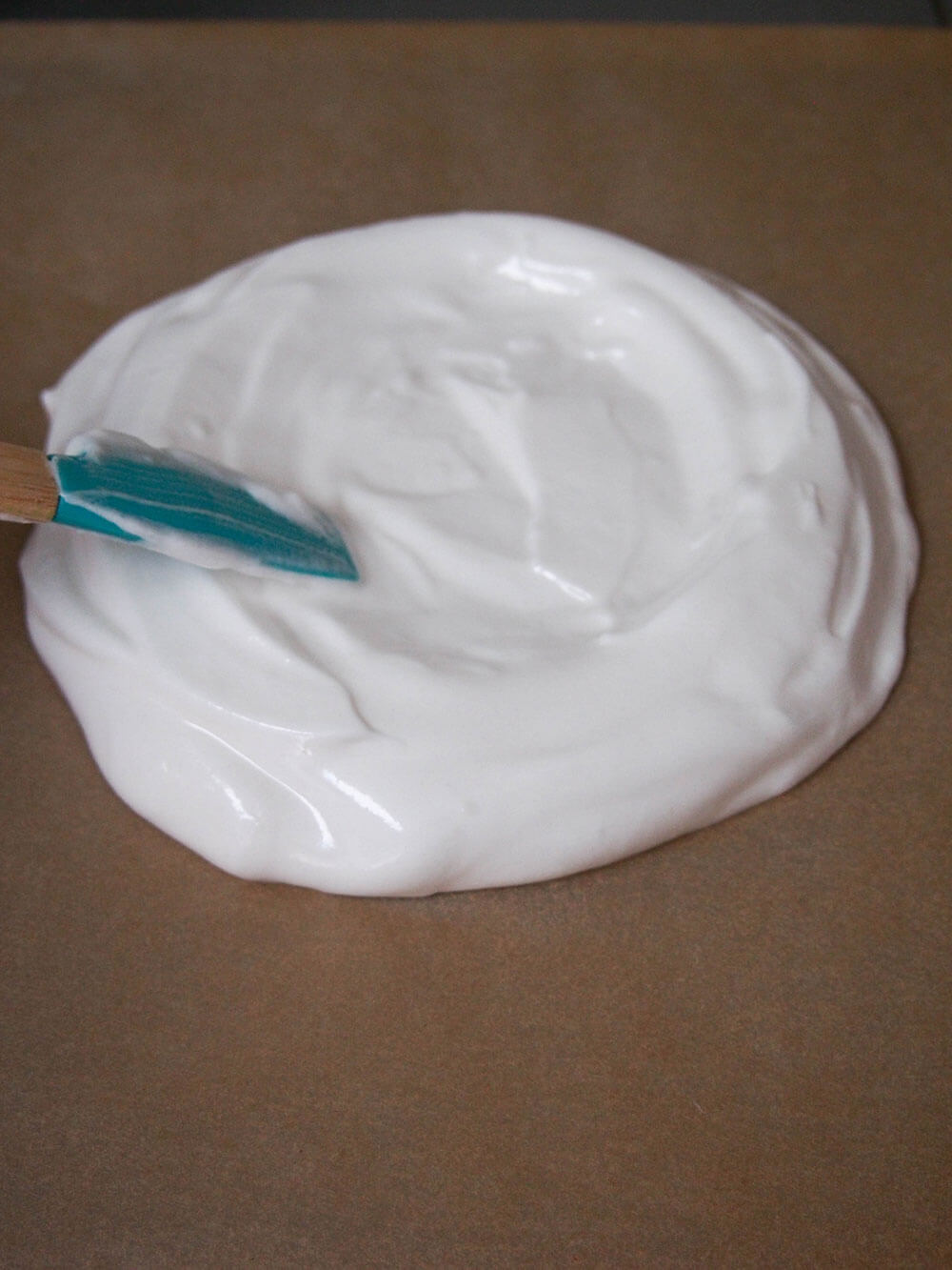 making pavlova for pavlova with raspberries and cream