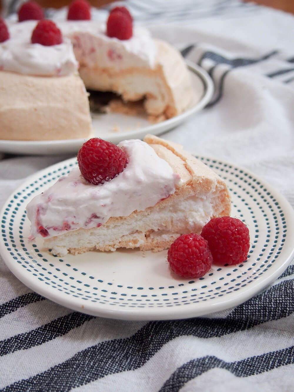 slice of pavlova with raspberries and cream