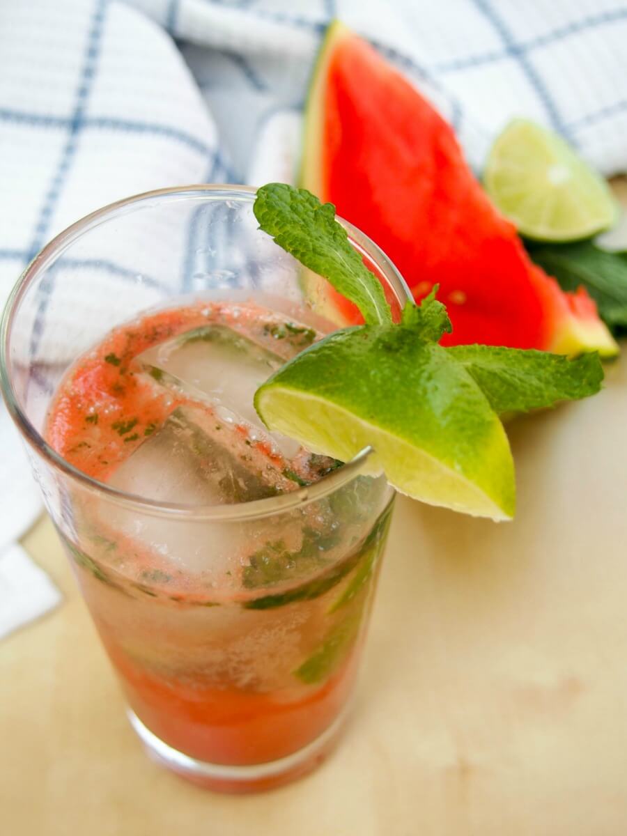 watermelon mojito made by muddling ingredients with bits of mint in drink