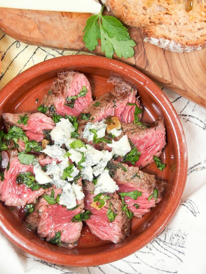 white wine marinated steak with blue cheese viewed from overhead