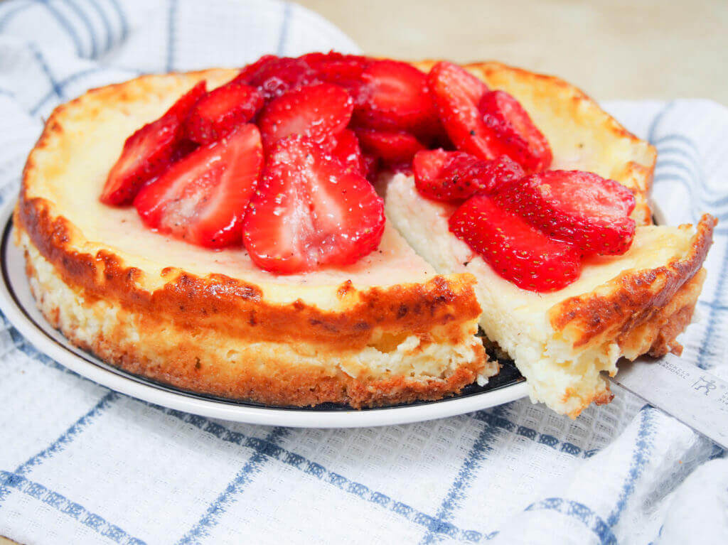 Swedish cheesecake with strawberries (ostkaka), made with cottage cheese and almonds, is not as sweet as an American cheesecake, but it's equally delicious. GF