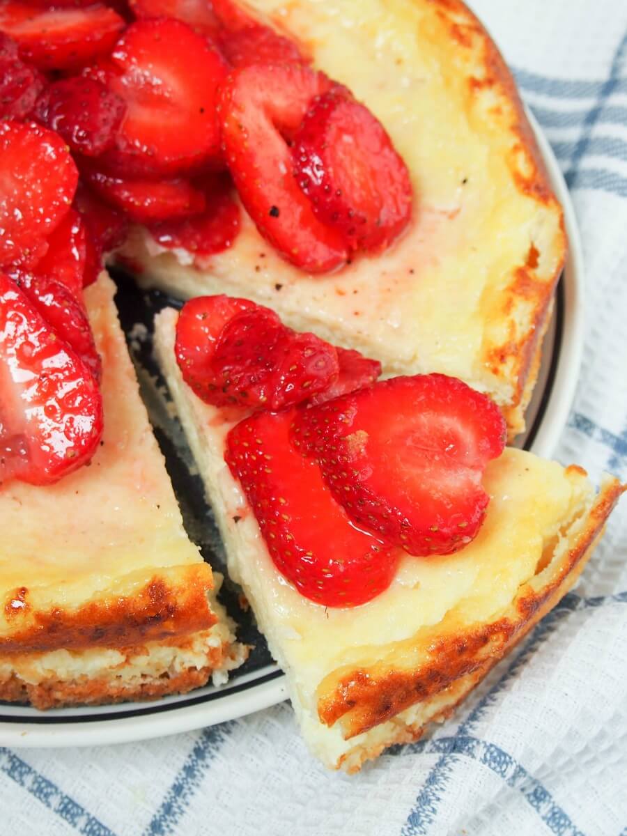 Swedish cheesecake ostkaka with slice being taken from it