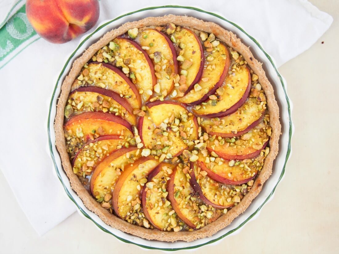 peach and pistachio tart viewed from overhead