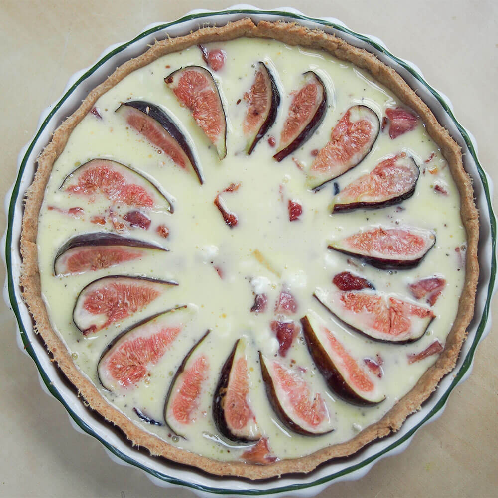 fig, goat's cheese and bacon quiche ready to bake