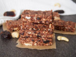 stack of no bake chocolate cashew bars with more behind