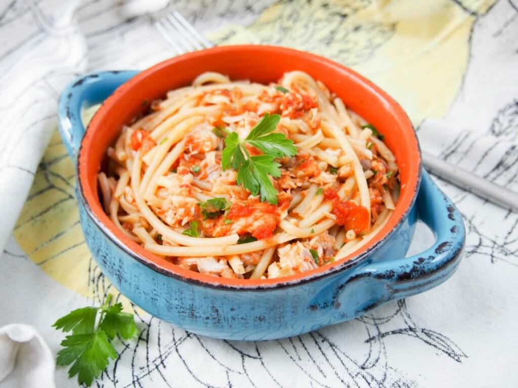 Fish ragu pasta is a tasty, simple combination of a tomato and fish-based sauce over pasta. Vary the fish for a fuller or fresher flavor, but all delicious.