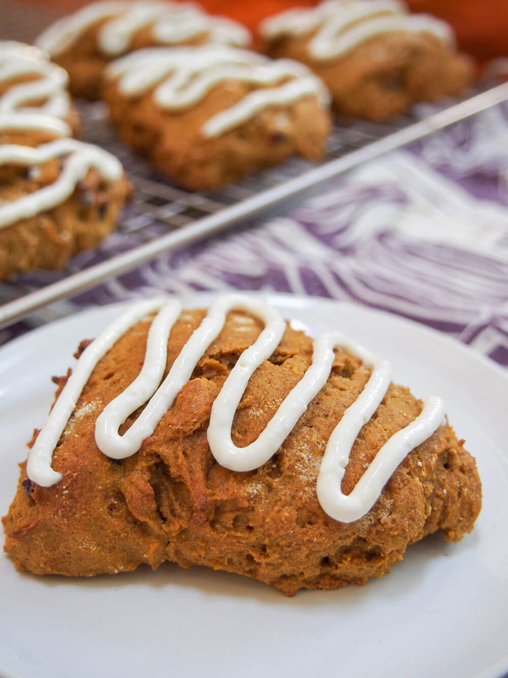 Healthy pumpkin scones with one scone on plate in front