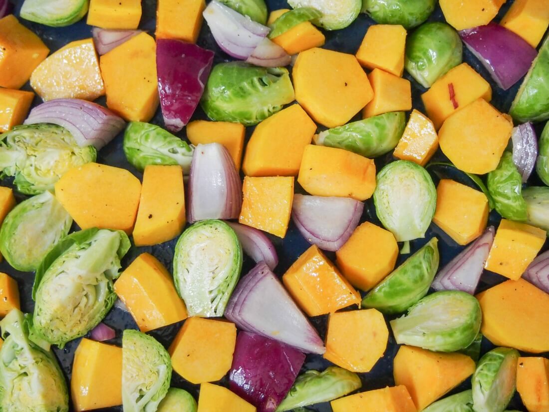 making acorn squash and Brussel sprout side dish