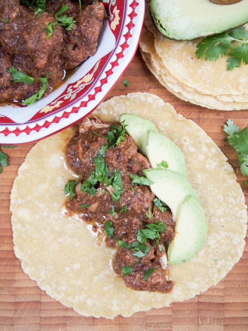 tortilla with mole chicken on top seen from overhead