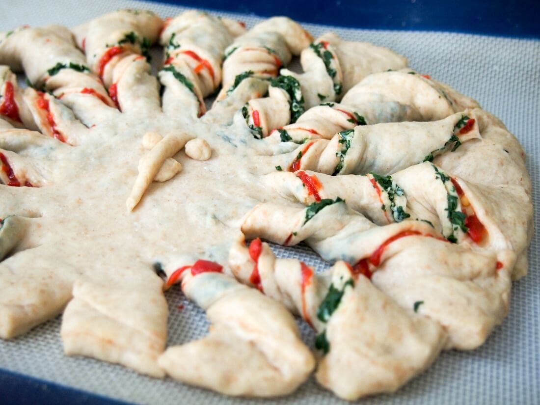 making twisted bread with peppers, spinach and parmesan