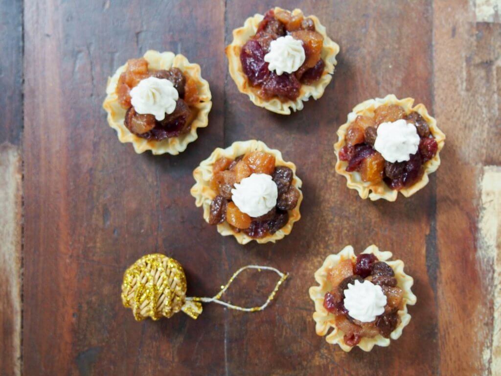 These mini mincemeat tarts are a super easy Christmas treat. Delicious, spiced fruit in crisp pastry with a creamy topping. Perfect Holiday entertaining finger food.
