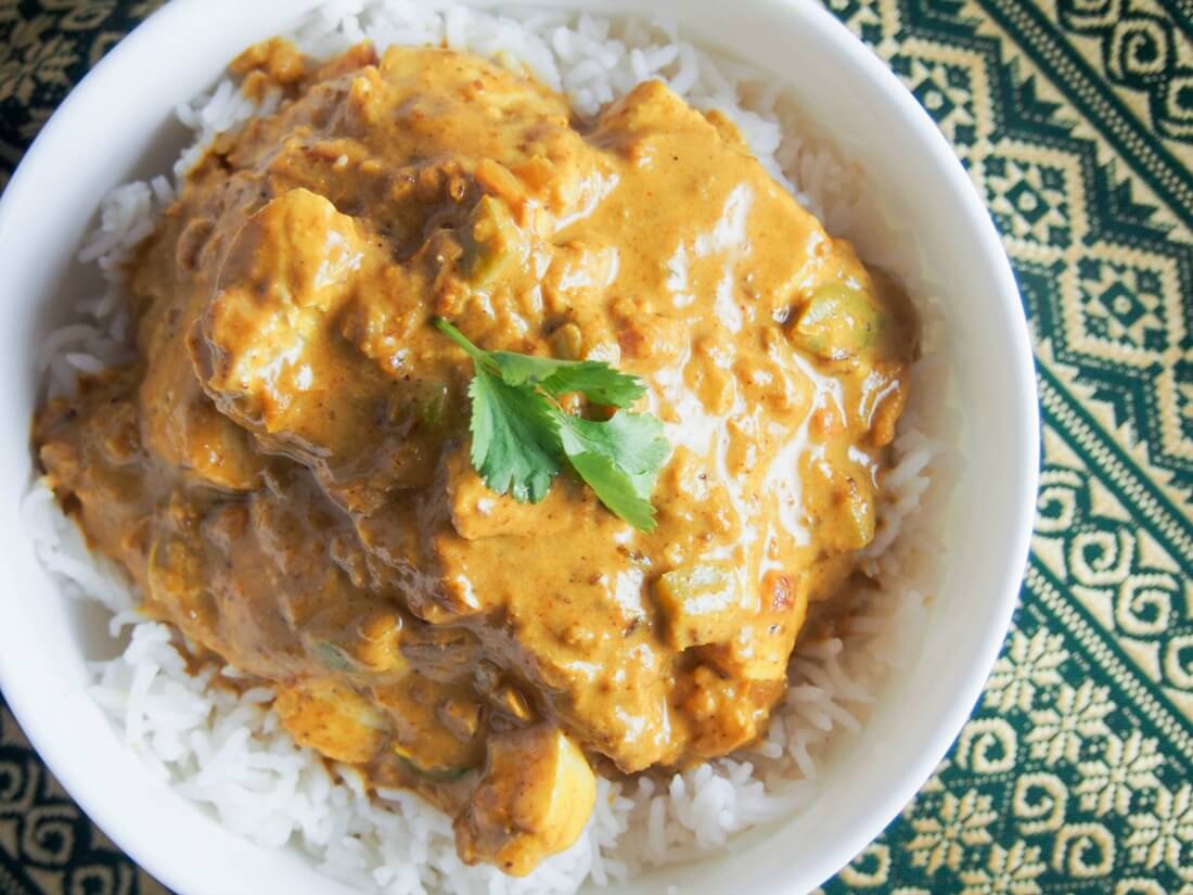 Goan fish curry over rice in bowl from overhead