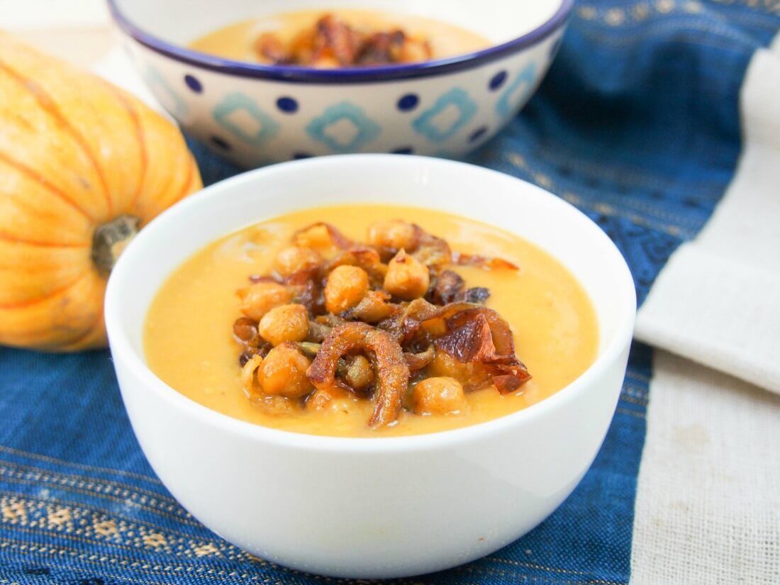 bowl of delicata squash soup with end of squash ad another bowl behind