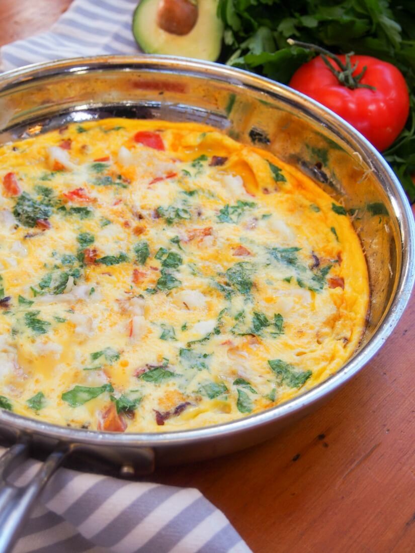 side view of bacon lobster omelette in skillet