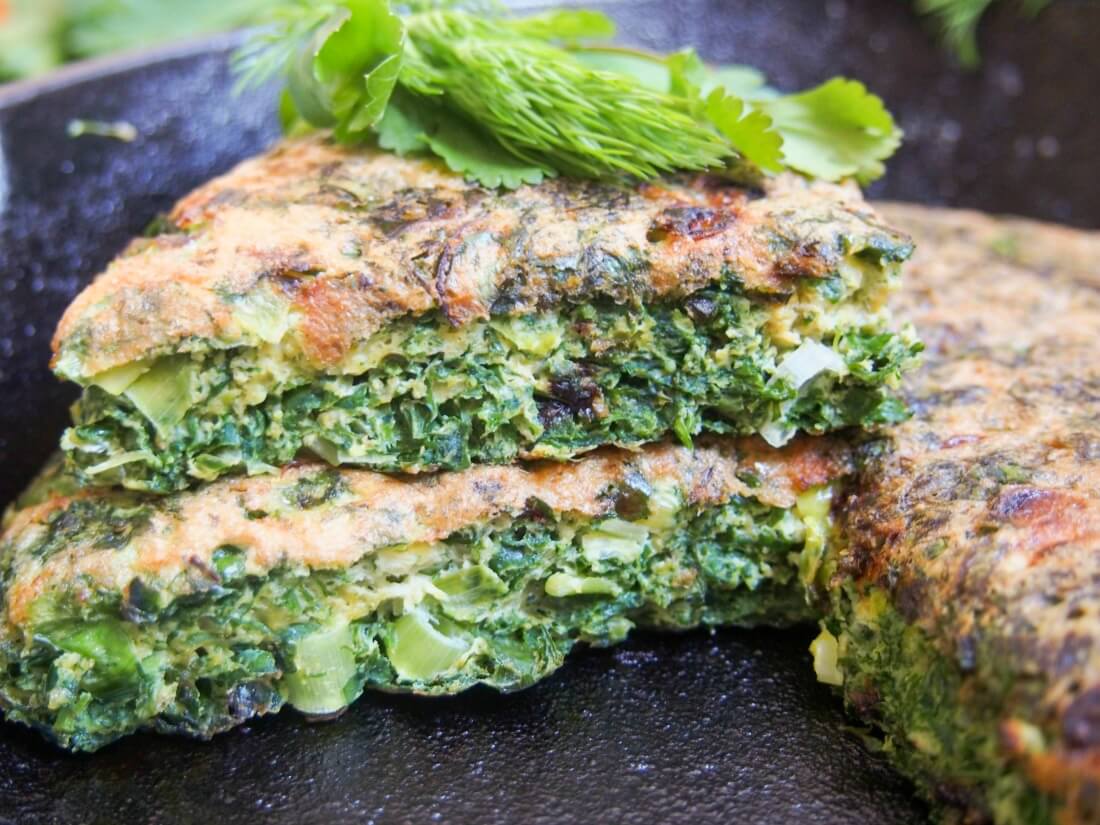 slice of kuku sabzi on top of rest of frittata