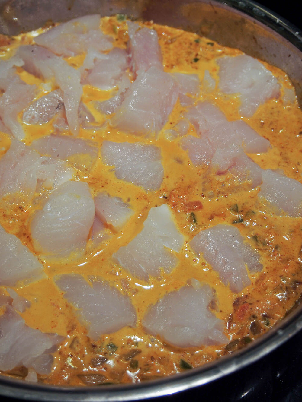 adding fish to curry base