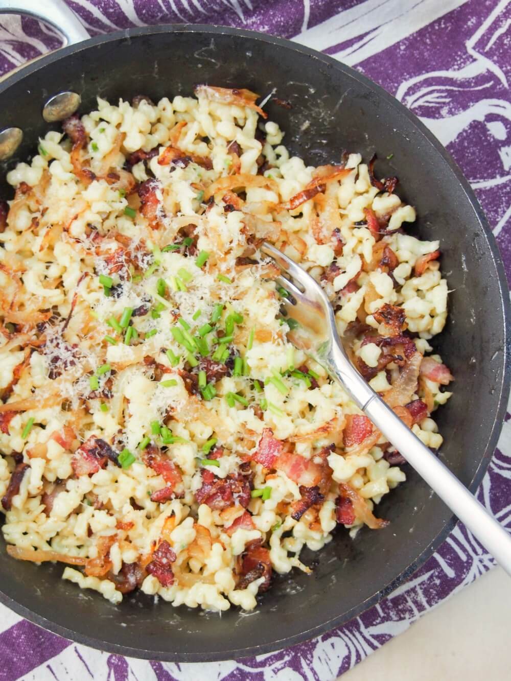 skillet of bacon onion spaetzle from overhead
