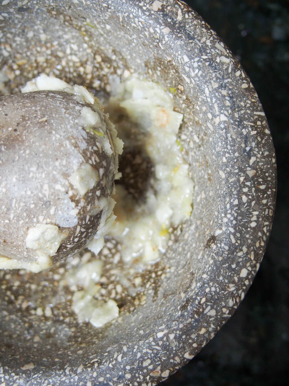 crushing garlic with pestle and mortar