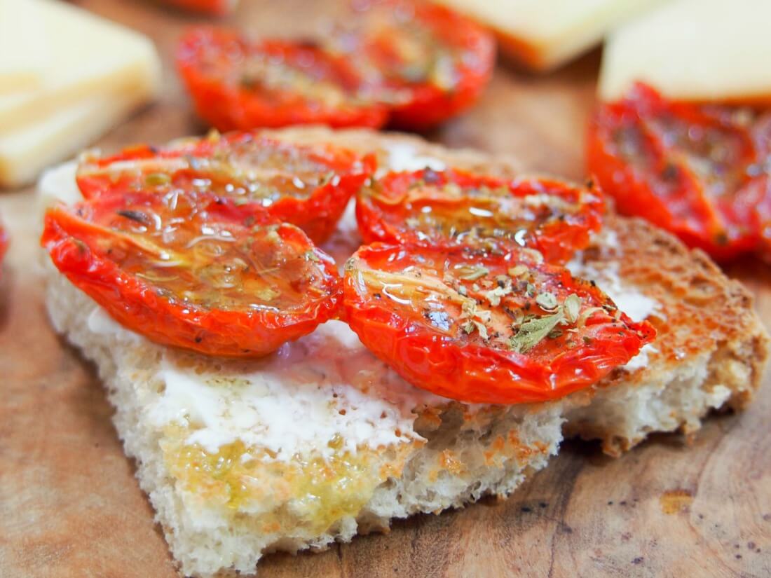 slow roasted tomatoes on piece of toast close up