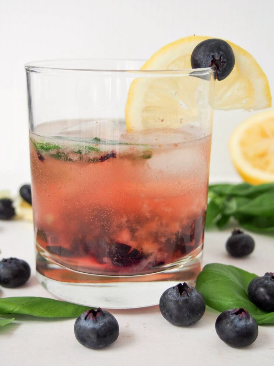 This bashful blueberry cocktail is a delicious mix of blueberries, lemon, vermouth, whiskey and a hint of basil. Topped with soda, it's a refreshing drink, perfect for summer
