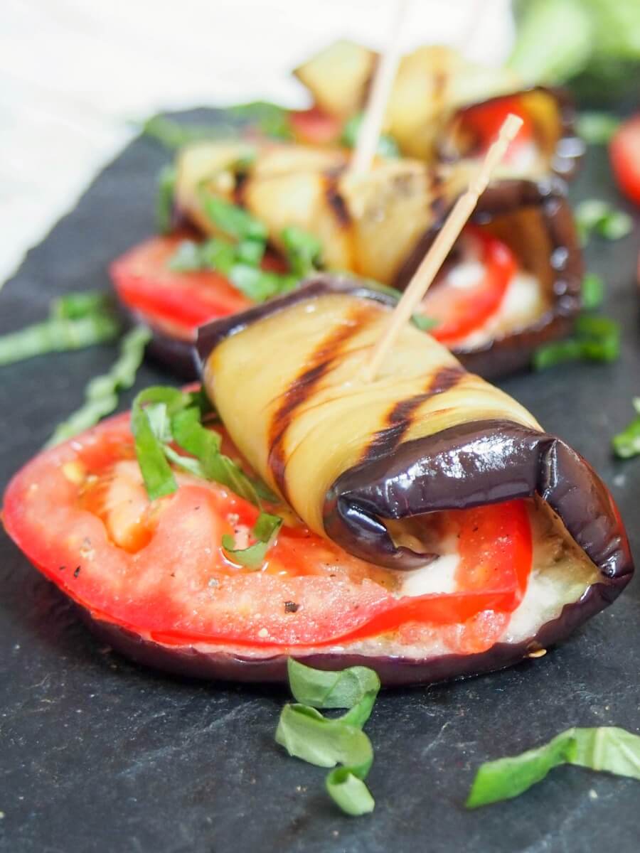 caprese eggplant roll ups help together with cocktail sticks close up on one at front