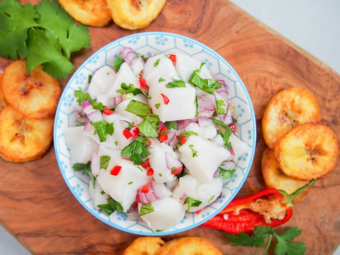 dish of scallop ceviche from overhead with plantain chips to side