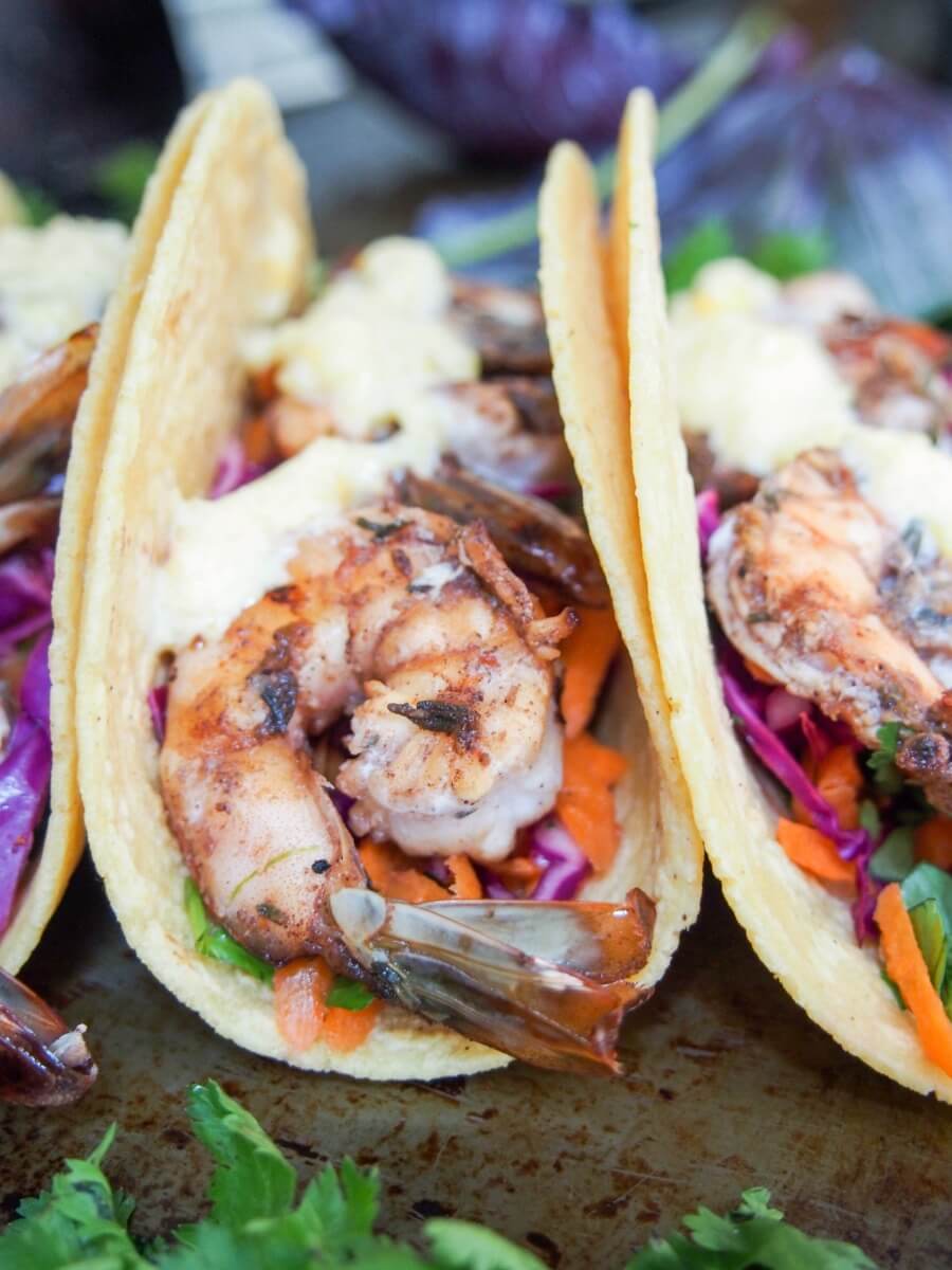 Spice marinated shrimp, a crunchy slaw and a sweet and creamy mango crema to top it all off - these jerk spiced shrimp tacos are so good (& easy too).