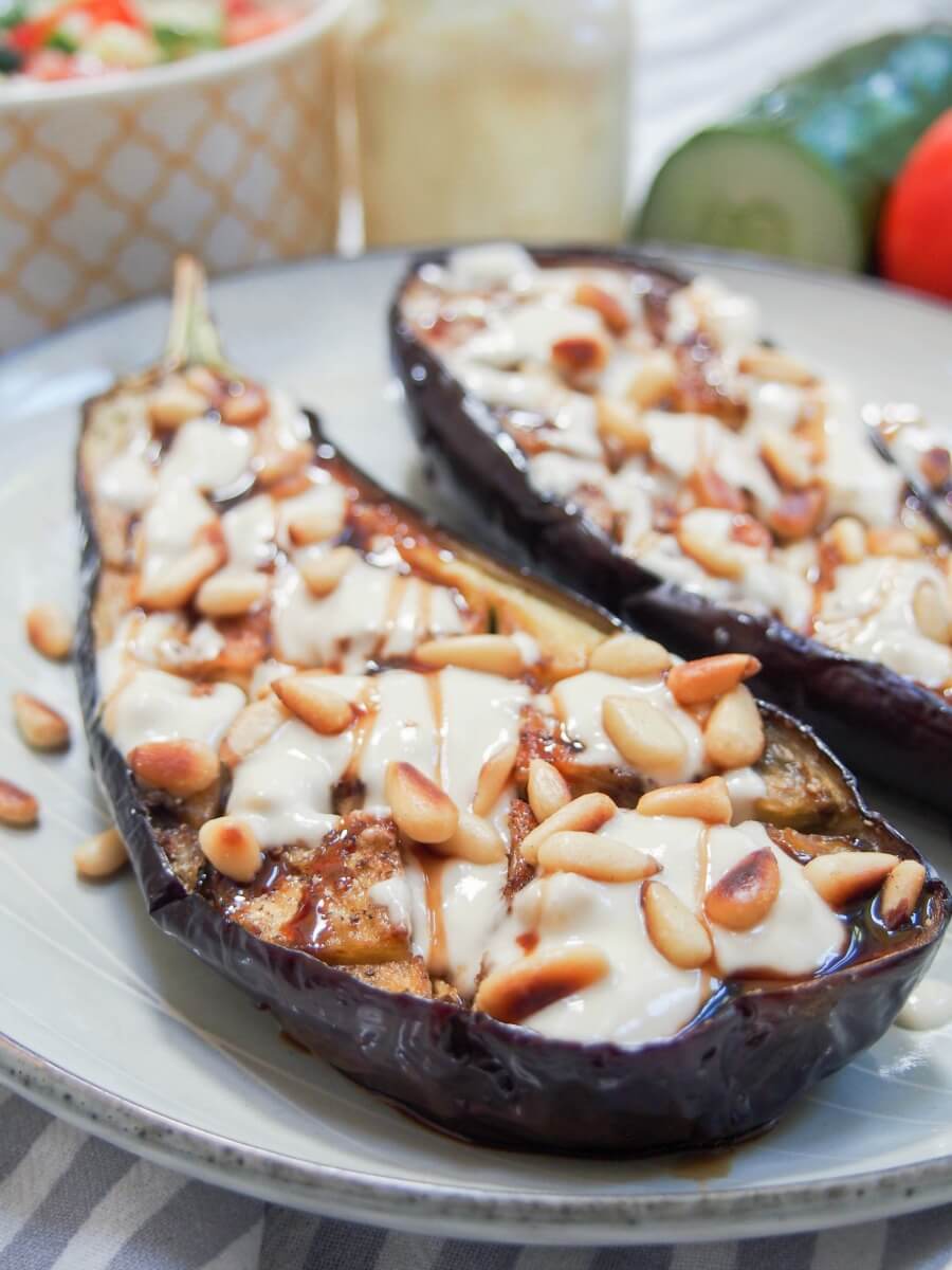 Roasted eggplant with tahini is a delicious appetizer or mezze dish that you'll find in Israel and other parts of the region. It's incredibly easy to make and full of fantastic flavor. Roasted eggplant with tahini viewed from one end