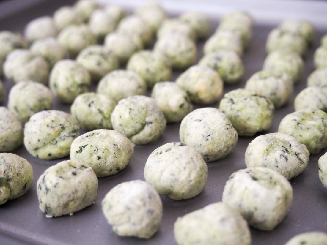 potato spinach gnocchi laid out in rows ready to cook