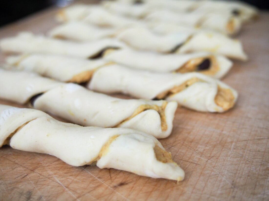 making chocolate pumpkin pastry twists twists of pastry with filling in them on board before baking