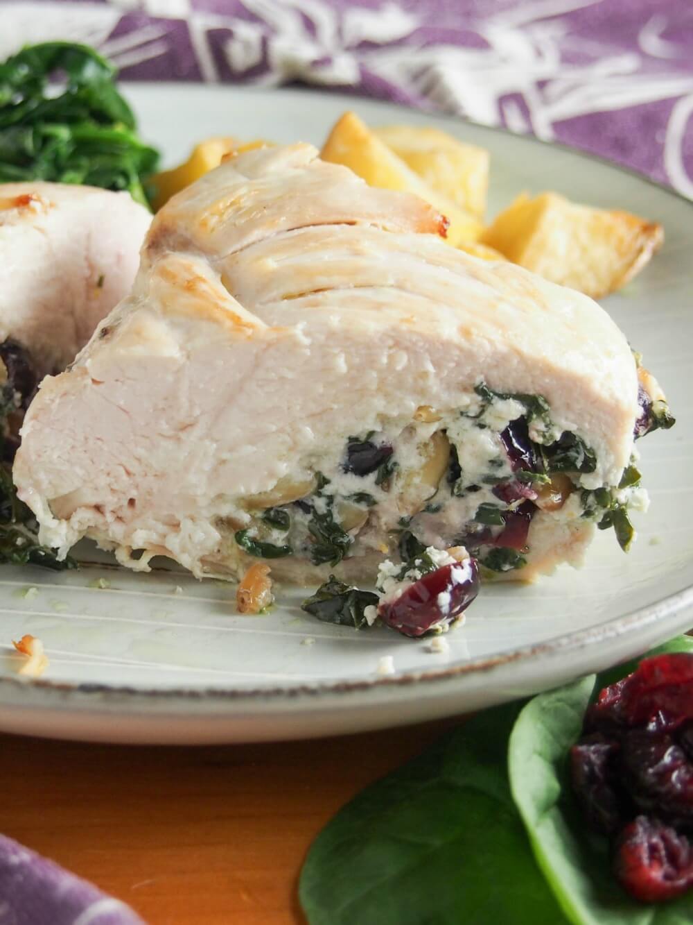 cut piece of goat cheese stuffed chicken showing stuffing inside