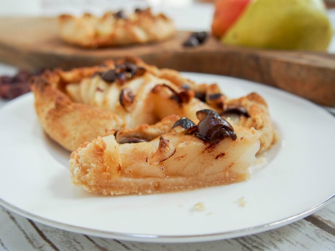 small slice of Individual pear galette in front of rest of tart on plate