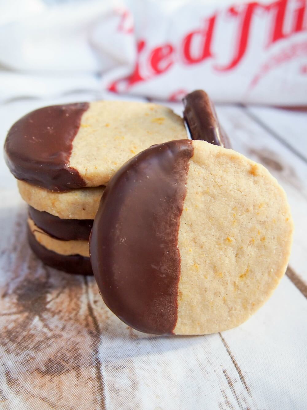 chocolate orange shortbread cookies in stack with one in front