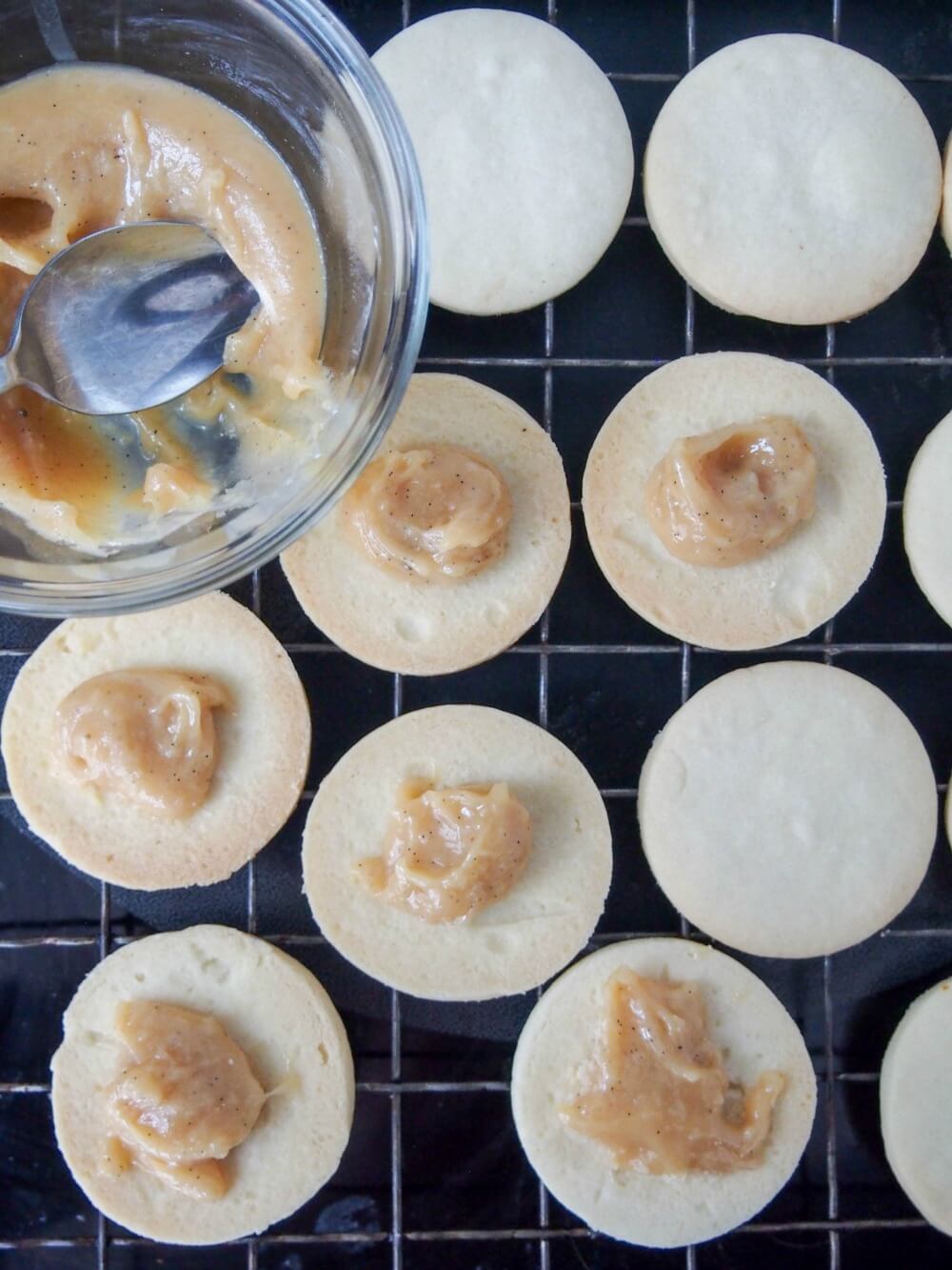 filling Alfajores with dulce de leche