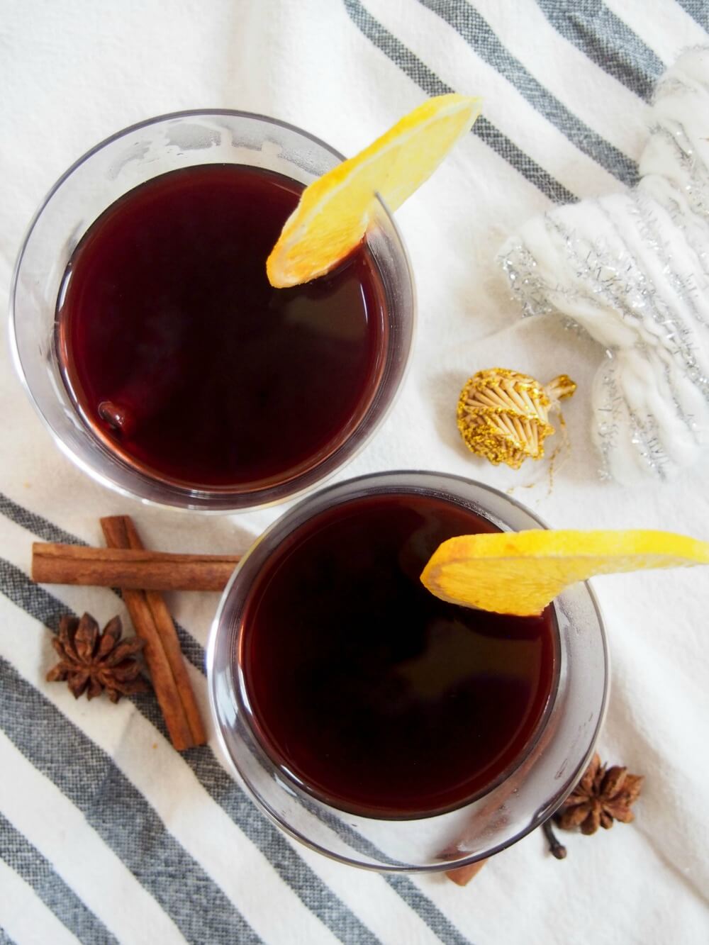 two glasses of German mulled wine from overhead with some of the spices to the side