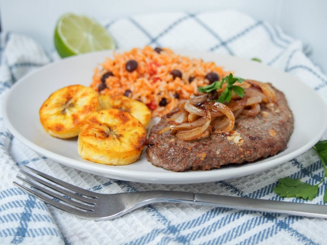 Cuban cube steak - bistec de Palomilla with fork in front of plate