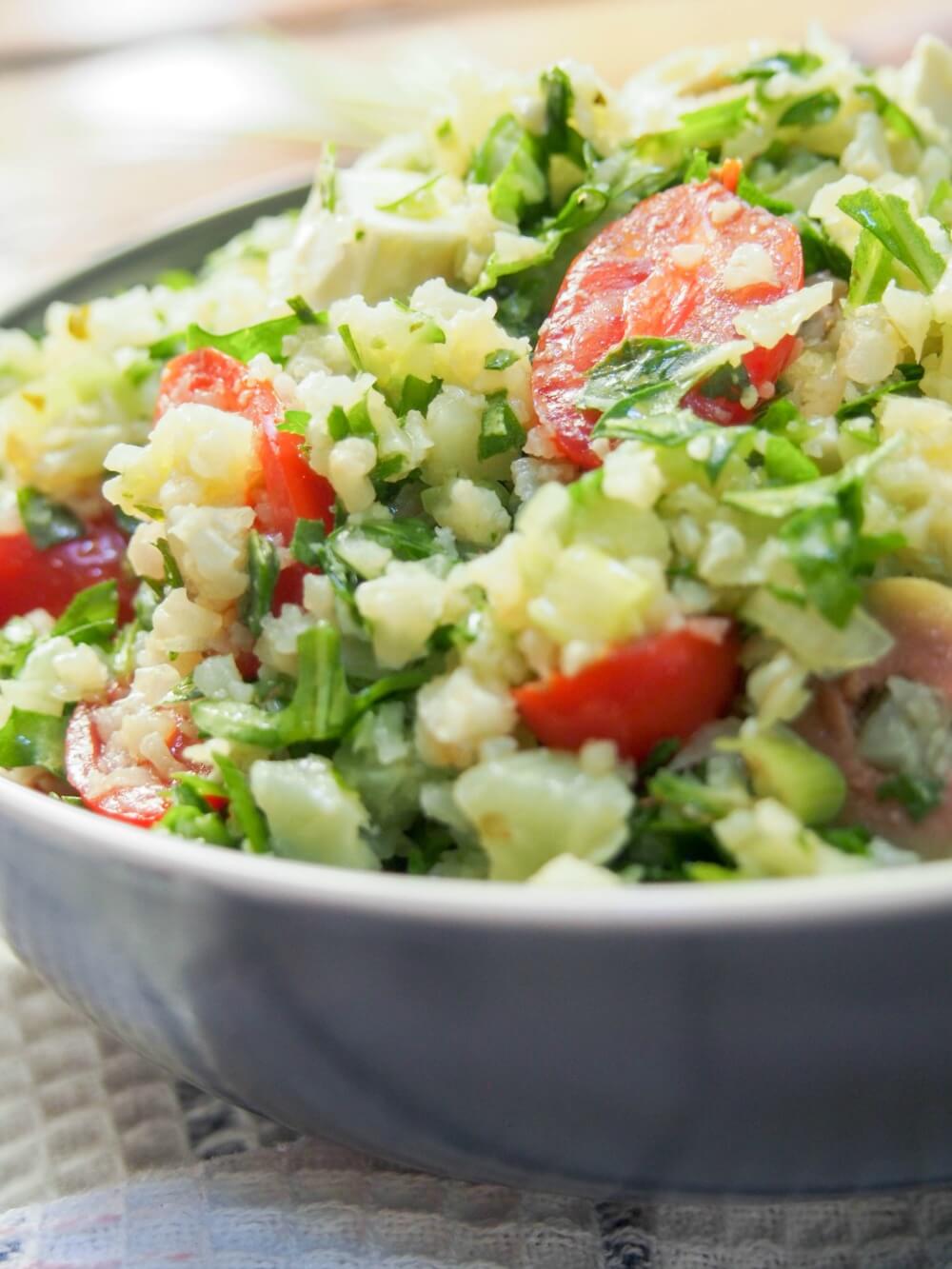 Greek-style cauliflower rice salad viewed close up from side