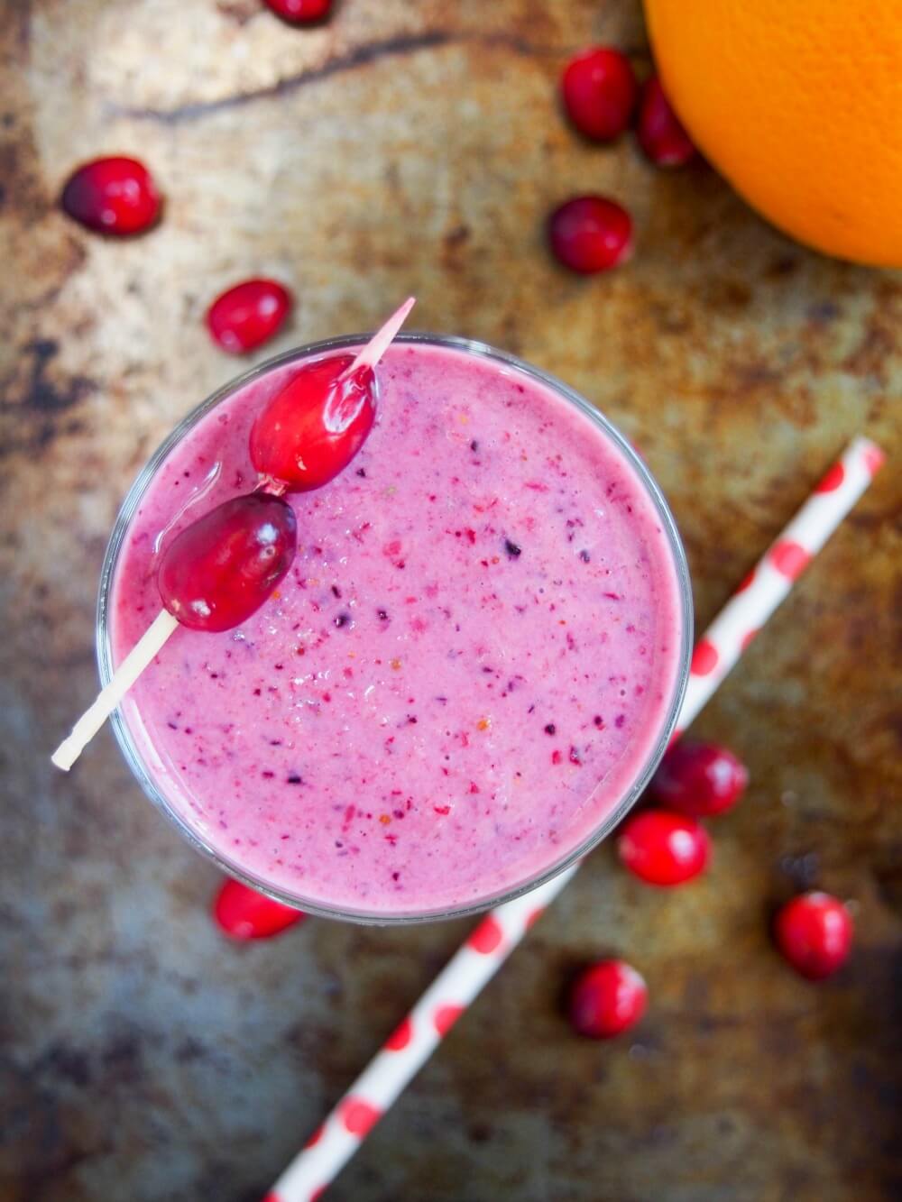 glass of cranberry smoothie from overhead with straw below