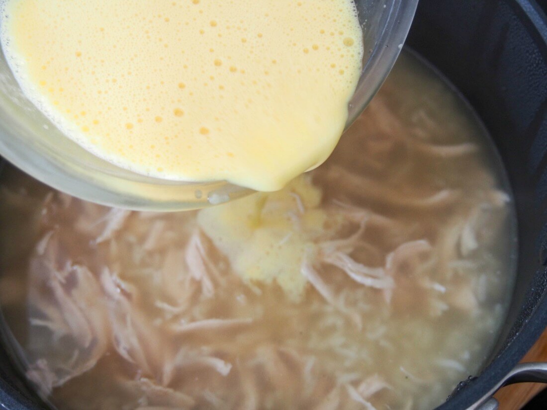pouring the avgolemono (lemon and egg mixture) into the soup