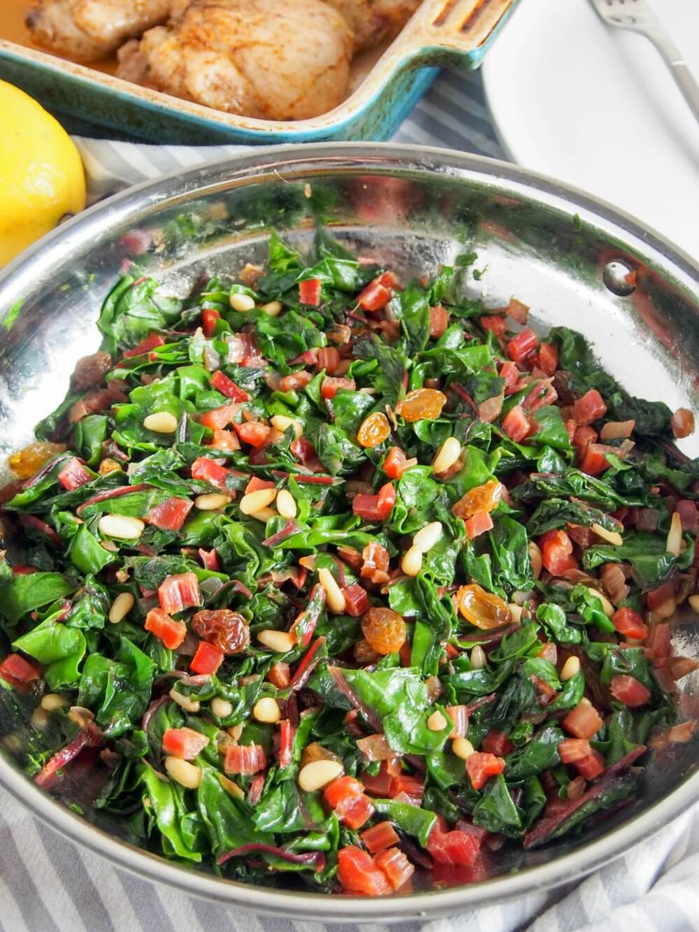 Whether you're a greens-sceptic or greens lover, this Catalan-style sauteed Swiss chard with raisins and pine nuts is an easy and delicious side dish, that's good for you too. pan with Catalan-style sauteed Swiss chard with raisins and pine nuts
