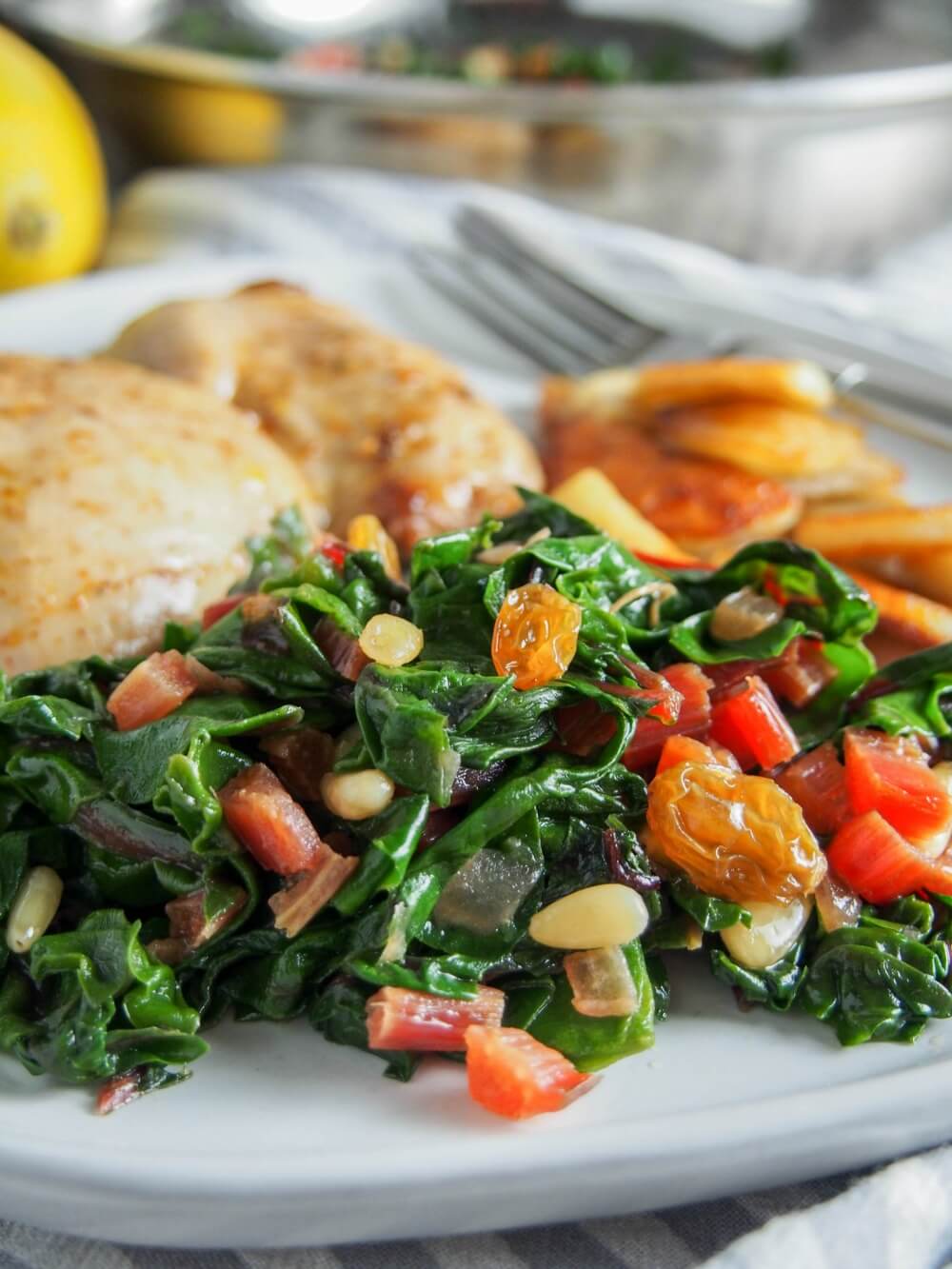 Whether you're a greens-sceptic or greens lover, this Catalan-style sauteed Swiss chard with raisins and pine nuts is an easy and delicious side dish, that's good for you too. Close up of Catalan-style sauteed Swiss chard