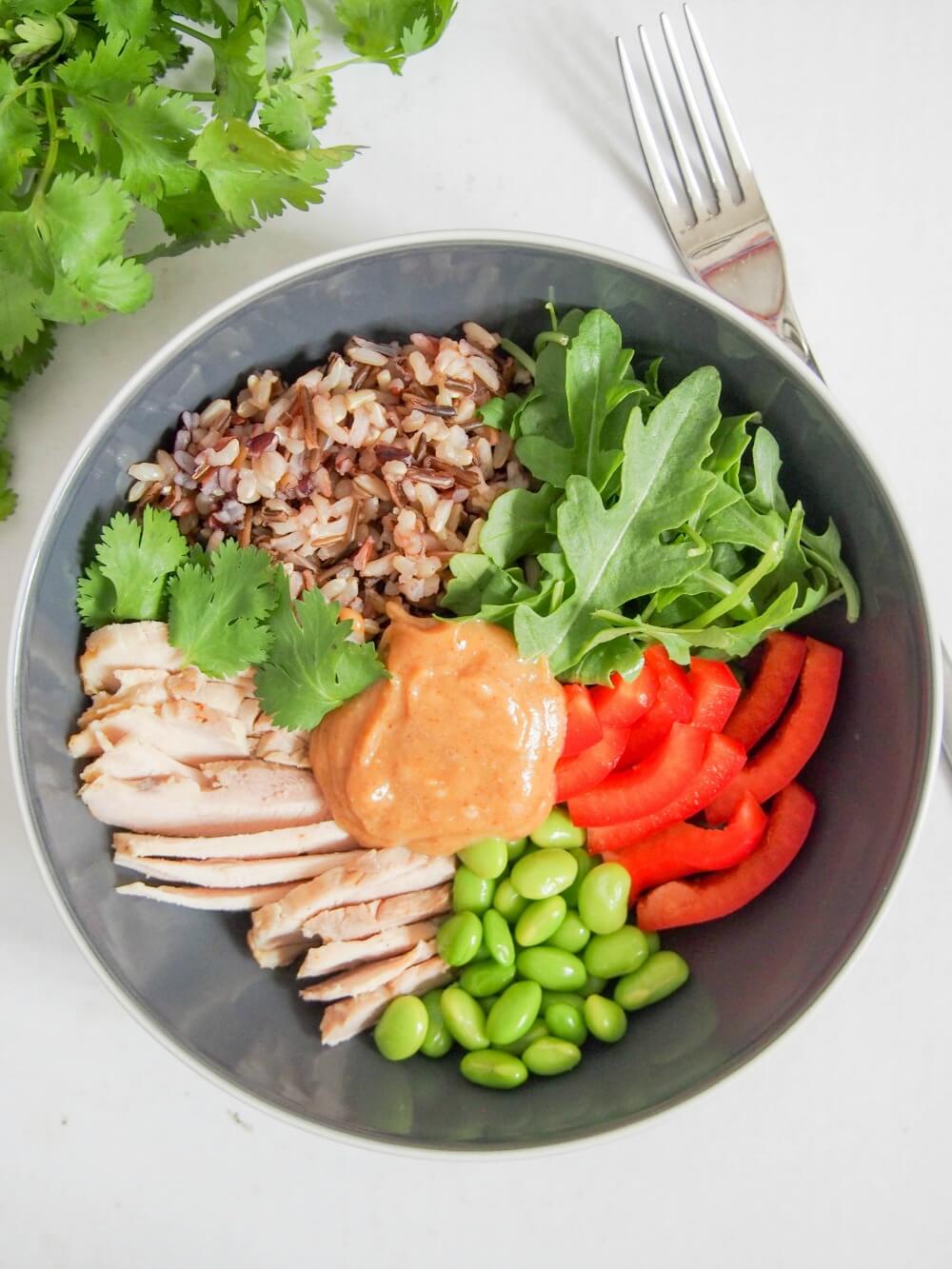 Thai-style leftover chicken Buddha bowl in bowl with fork to side