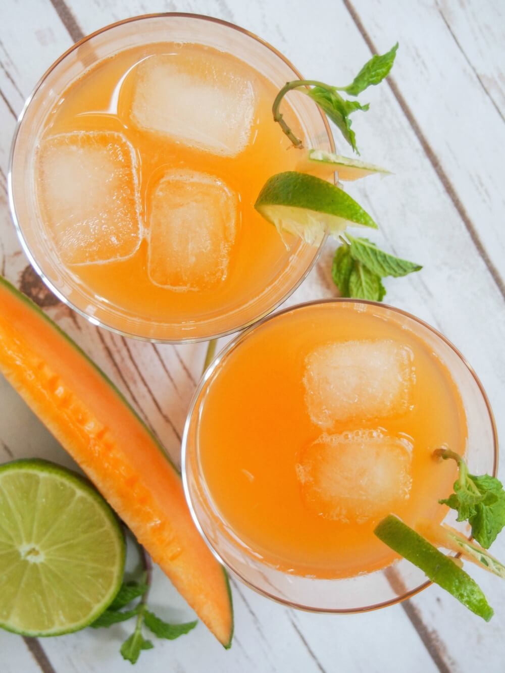 two glasses of cantaloupe agua fresca from overhead
