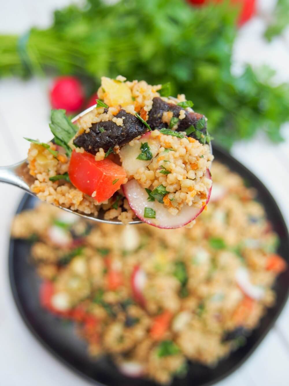 spoonful of couscous salad with prune vinaigrette