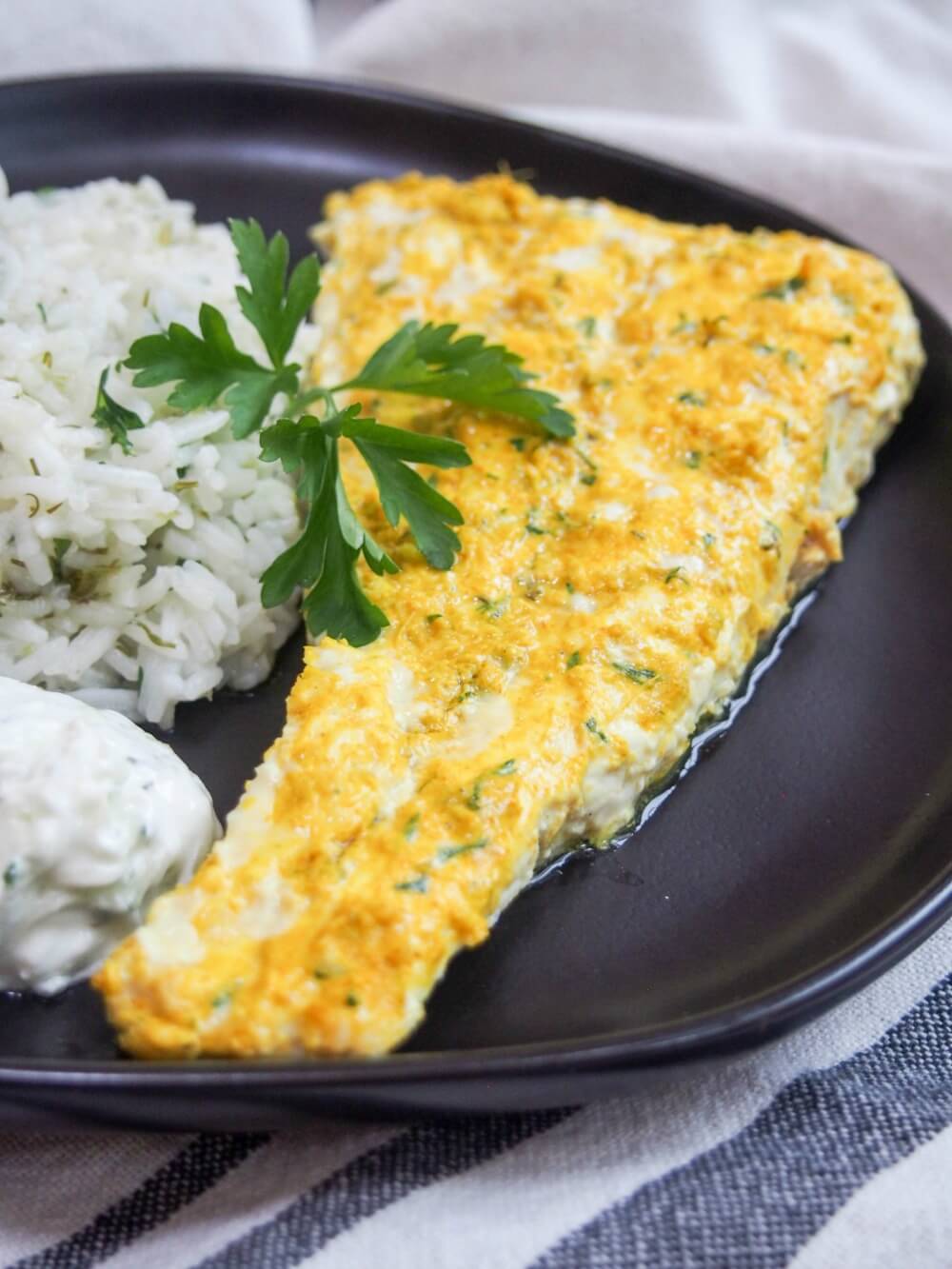 This Persian-style marinated fish is delicately, and deliciously flavored with a lightly spiced lime and yogurt marinade. It's easy to make and a wonderful change from plain old fish. Persian style marinated fish with cacik and herb rice