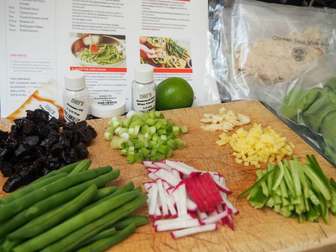 preparing ingredients for Chef'd meal kit: Asian chicken and California prunes lettuce wraps